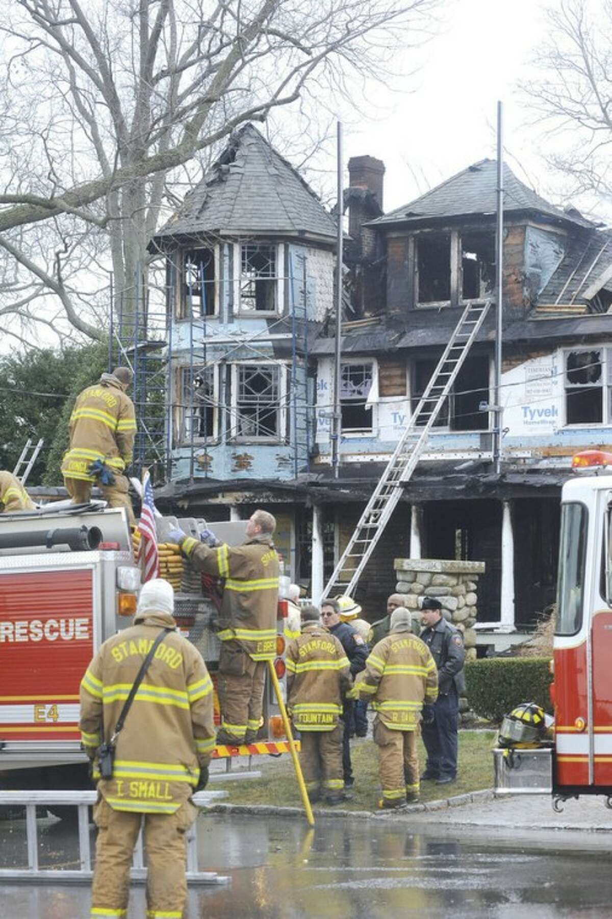 File Photo / Matthew Vinci. Stamford Fire & Rescue teams work outside of a home at 2267 Shippan Ave. in Stamford after a fire broke out Christmas Day 2011, killing five occupants.