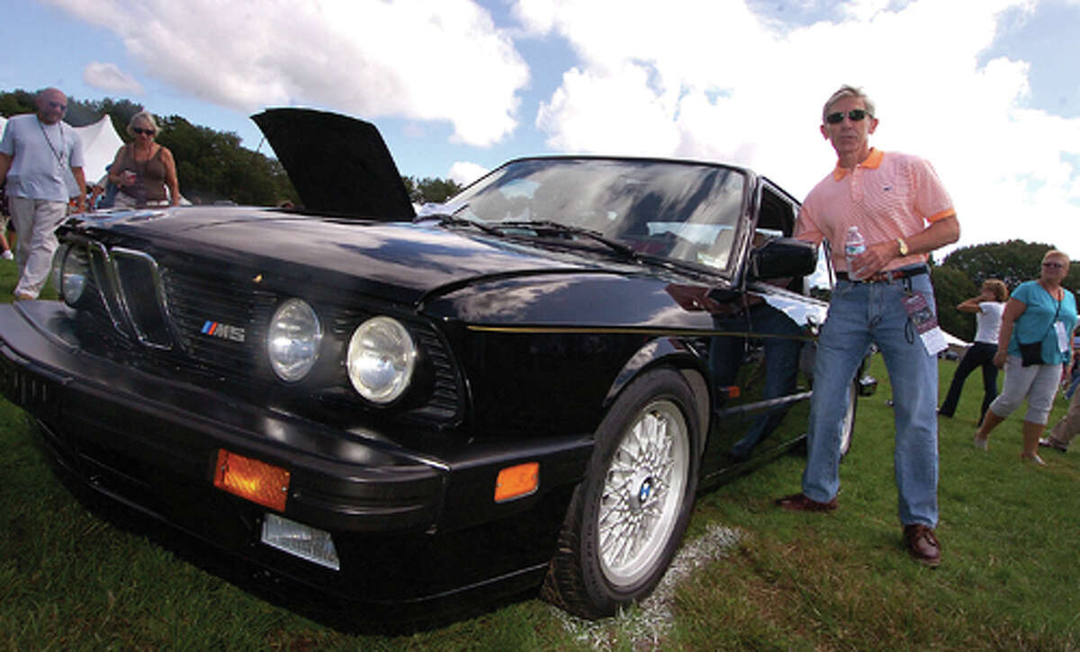 Photo/Alex von Kleydorff. Stamfords Roger Pearson makes sure his entry, a 1988 BMW M5 looks its best for judging at this past wekend's Fairfield County Concours D'Elegance in Westport