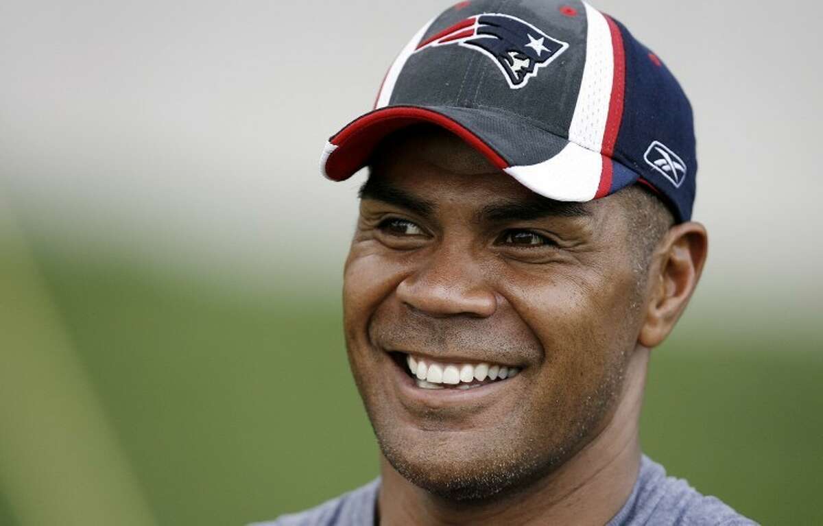 FILE -In this July 28, 2007 file photo, New England Patriots linebacker Junior Seau smiles during NFL football training camp in Foxborough, Mass. Police say Seau, a former NFL star, was found dead at his home in Oceanside, Calif., Wednesday, May 2, 2012, after responding to a shooting there. He was 43. (AP Photo/Winslow Townson, File)