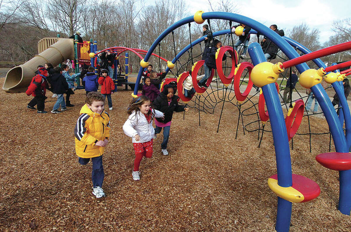 @Cutline Byline:Hour photos / Alex von Kleydorff @Cutline:Above, Wolfpit Elementary School second-graders check out new playgrounds after a ribbon-cutting ceremony at the school Monday. Left, Wolfpit Assistant Principal Christopher Weiss cuts the ribbon. One playground will serve kindergarten students, while the other will be used by older children. The parks were designed by Peter R. Wallace of O'Brien & Sons, with construction overseen by the Department of Parks and Recreation.