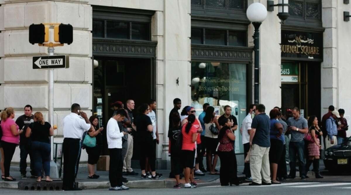 People stand outside after a temporary evacuation from office buildings in Jersey City, N.J., Tuesday, Aug. 23, 2011. One of the strongest earthquakes ever recorded on the East Coast shook buildings and rattled nerves from South Carolina to New England. (AP Photo/The Jersey Journal, Andrew Miller)