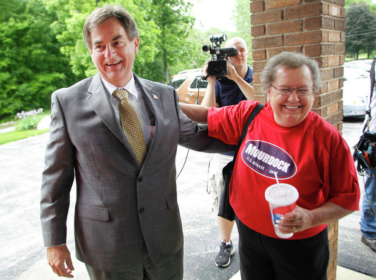 Republican U. S. Senate candidate Richard Mourdock is greeted by supporter Johanna Fultz as he makes a campaign stop Monday, May 7, 2012, at Immanuel Reformed Presbyterian Church near Battle Ground, Ind. Fultz traveled from Logansport to see Mourdock. Mourdock is running against incumbent Sen. Dick Lugar. (AP Photo/Journal & Courier, John Terhune)