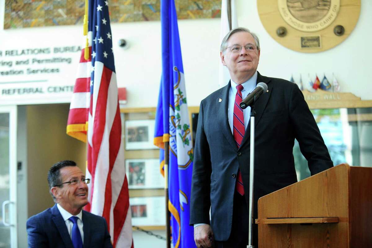 Stamford Mayor David Martin speaks during a press conference announcing an energy efficiency partnership between the city and Eversource inside Government Center on Tuesday. Also pictured is Gov. Dannel Malloy (left).