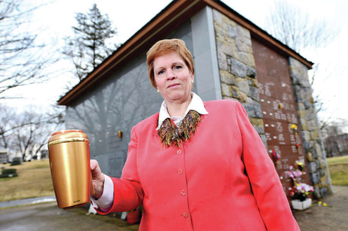 Hour photo / Erik Trautmann Above, Shelly Timber, general manager at Riverside Cemetery, reports that 10 bronze vases, worth about $500 each, were stolen from a community mausoleum at the cemetery on Sunday.