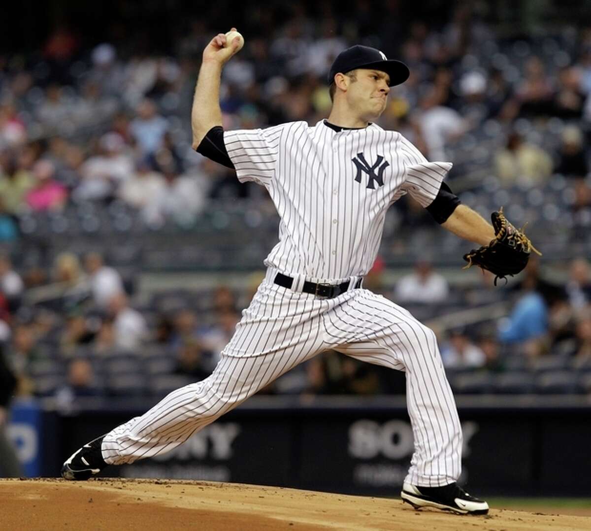New York Yankees starting pitcher David Phelps delivers against the Tampa Bay Rays in the second inning during their baseball game at Yankee Stadium in New York, Wednesday, May 9, 2012. (AP Photo/Kathy Willens)