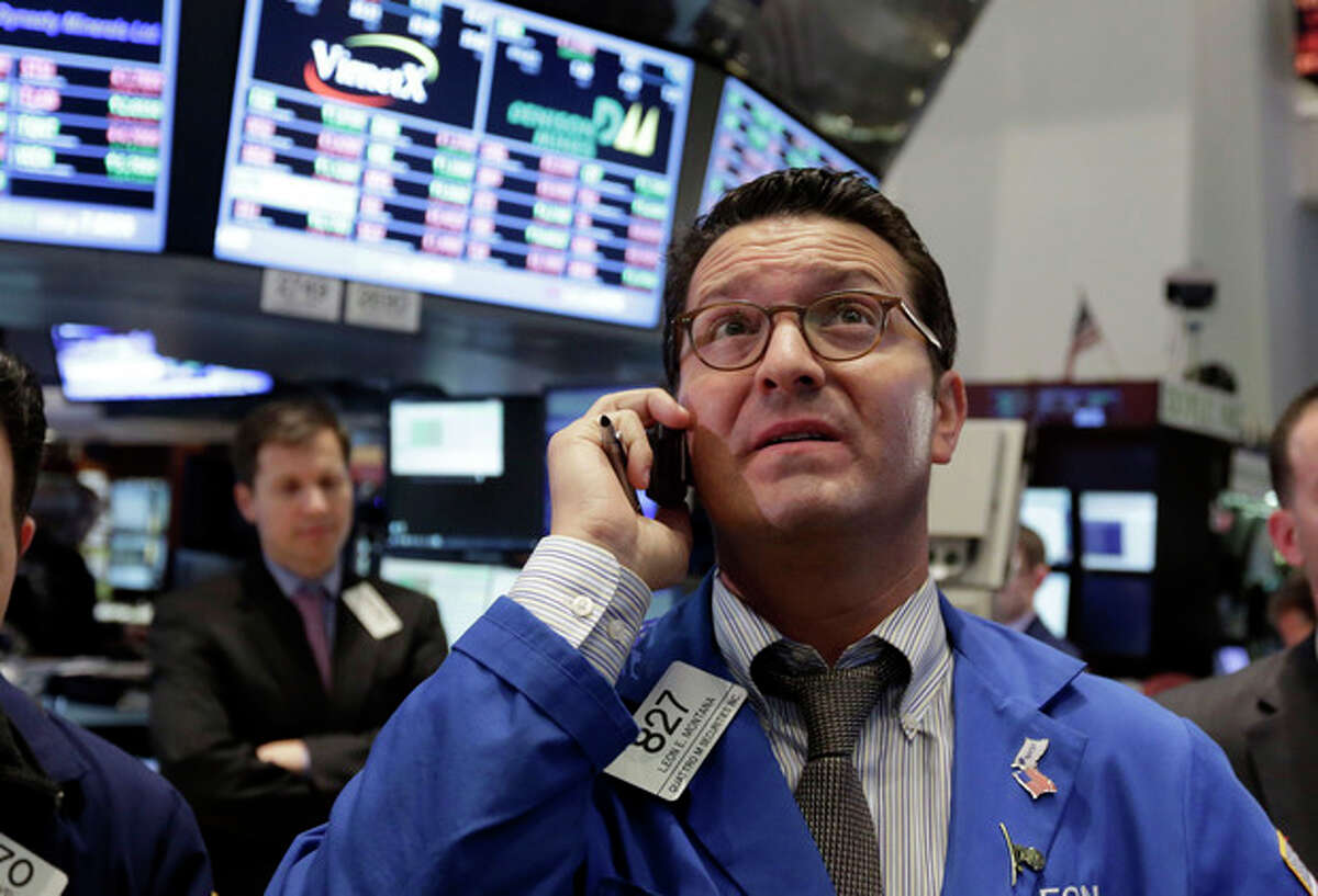 Trader Leon Montana, right, works on the floor of the New York Stock Exchange Thursday, Feb. 28, 2013. The stock market pushed higher Thursday afternoon, sending the Dow tantalizingly close to a record high. (AP Photo/Richard Drew)