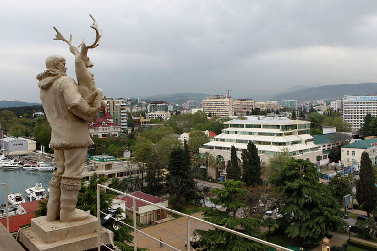 In this photo taken on Thursday, May 19, 2011, an old Soviet style statue of a reindeer breeder, left, is seen over the Black Sea resort of Sochi, southern Russia. Russia's secret service said Thursday, May 10, 2012, that it had foiled terror attack plans in the Black Sea resort of Sochi ahead of the 2014 Winter Games. The FSB said it suspects the attacks were being masterminded by Doku Umarov. The FSB also said that it suspects that Umarov has close links to the secret service in Georgia. .(AP Photo/Alexander Zemlianichenko, file)