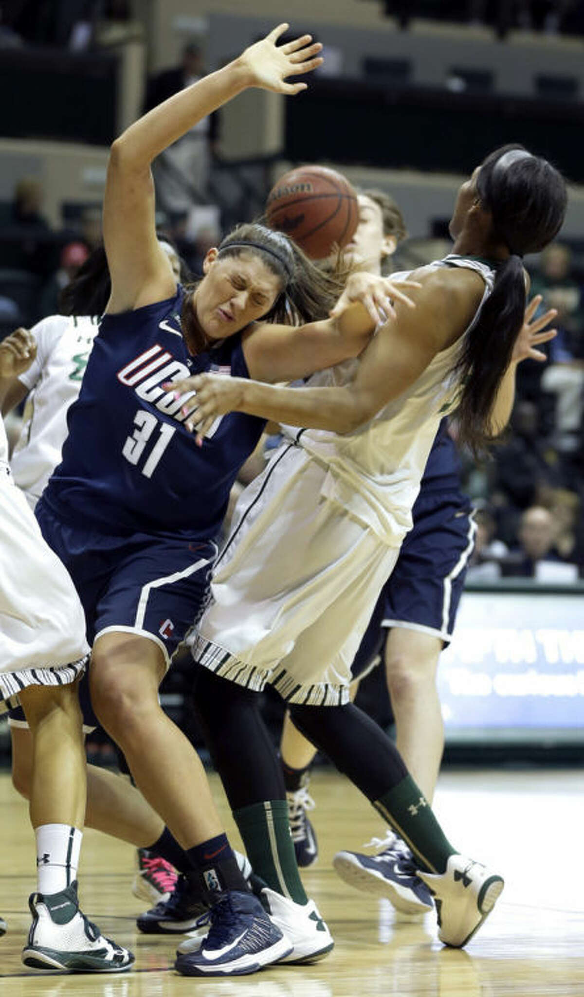 Connecticut center Stefanie Dolson (31) gets fouled by South Florida center Akila McDonald (32) during the first half of an NCAA college basketball game Saturday, March 2, 2013, in Tampa, Fla. (AP Photo/Chris O'Meara)