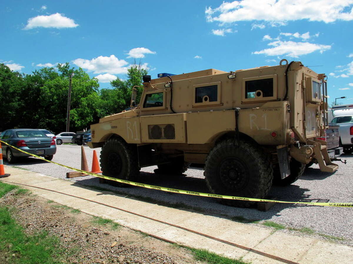 An armored vehicle sits in the parking lot of a command center set up to coordinate the search for two Tennessee girls and the man accused of abducting them and killing their mother and sister on Thursday May 10, 2012, in Guntown, Miss. The hunt for Adam Mayes and the two young sisters he is accused of kidnapping has encompassed parts of at least three counties in northern Mississippi. (AP Photo/Adrian Sainz)