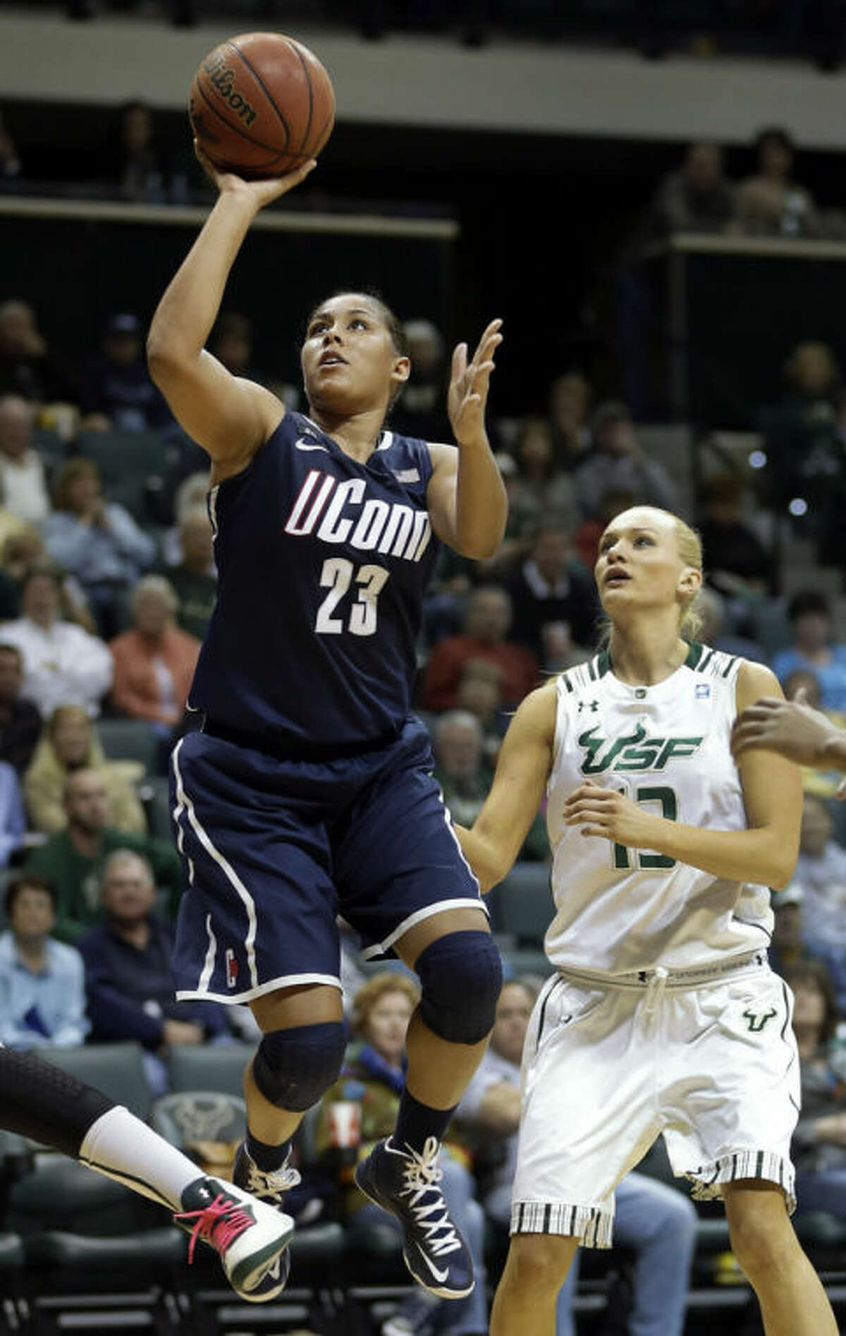 Connecticut forward Kaleena Mosqueda-Lewis (23) shoots past South Florida guard Inga Orekhova (13) during the second half of an NCAA college basketball game Saturday, March 2, 2013, in Tampa, Fla. Mosqueda-Lewis had 32 points in UConn's 85-51 win. (AP Photo/Chris O'Meara)