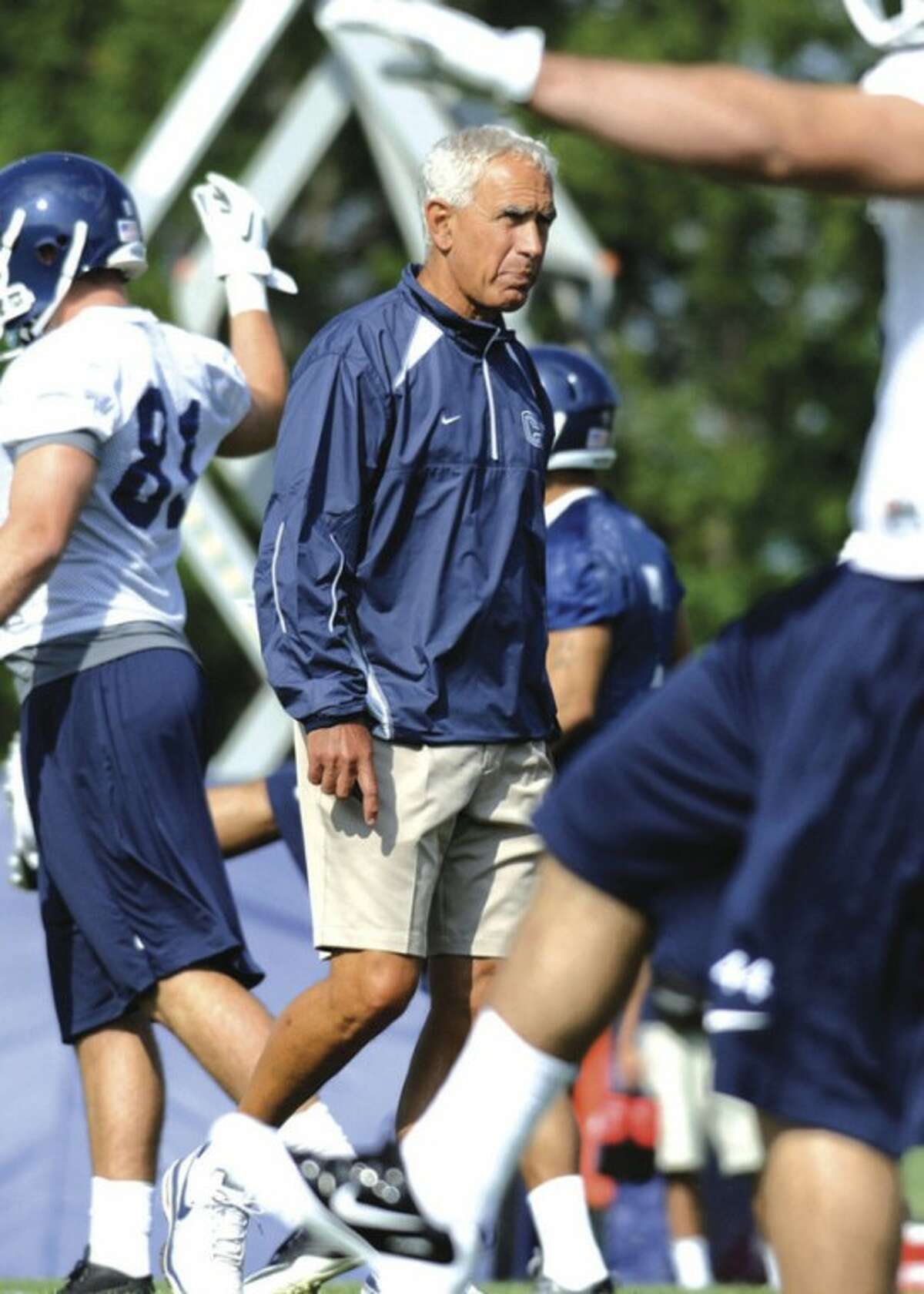 @White=[C] AP photo New UConn coach Paul Pasqualoni walks among his players during a recent practice. The Huskies not only have a new coach, but their offensive backfield is basically an all-new unit.