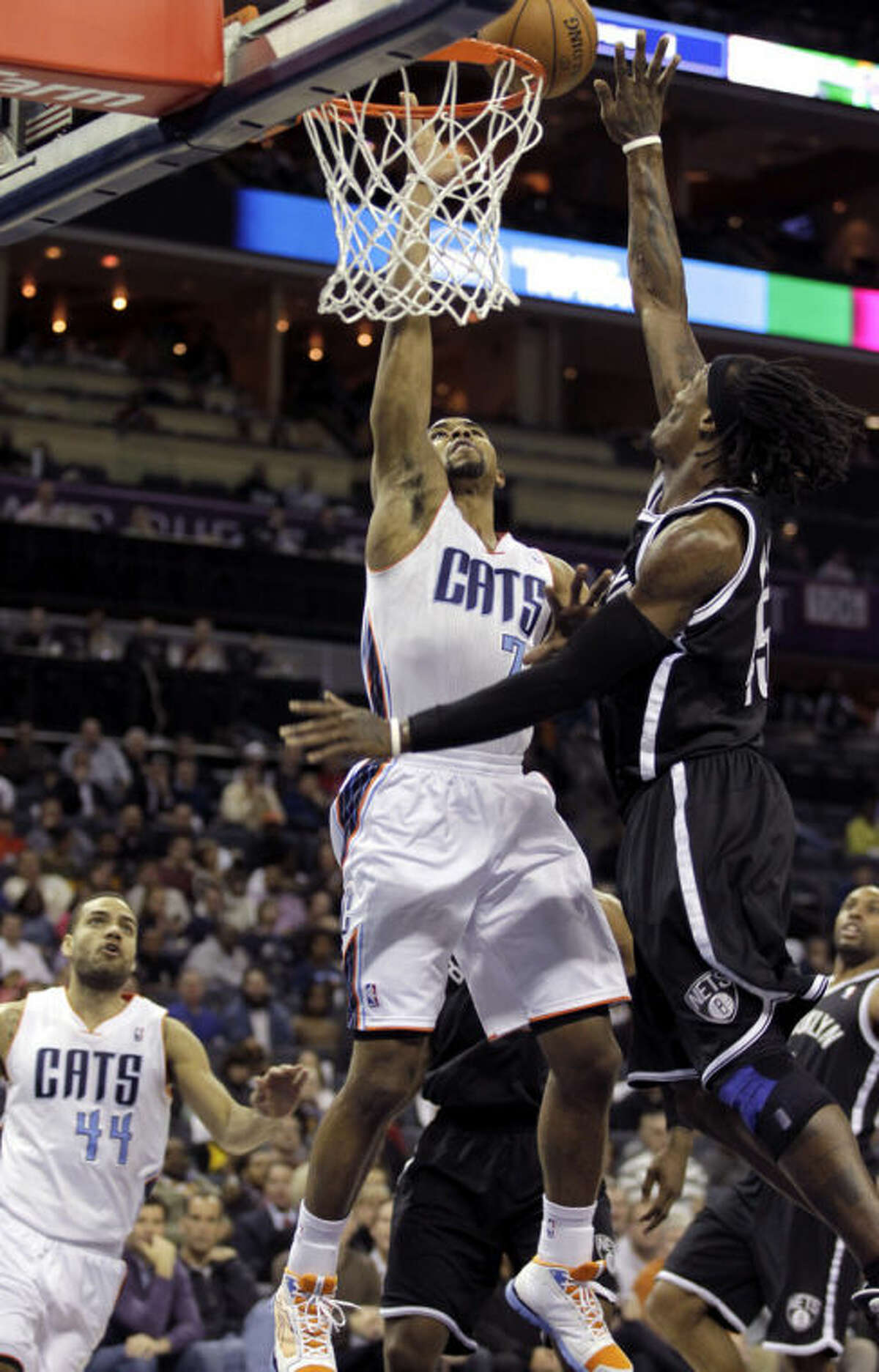 Charlotte Bobcats' Ramon Sessions (7) has his shot blocked by Brooklyn Nets' Gerald Wallace (45) during the first half of an NBA basketball game in Charlotte, N.C., Wednesday, March 6, 2013. (AP Photo/Bob Leverone)