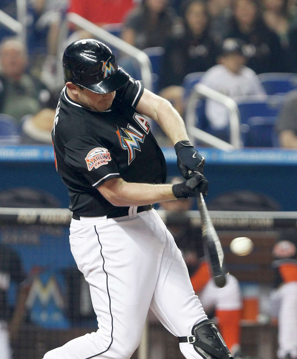 Miami Marlins' Austin Kearns hits a home run, scoring Omar Infante, during the first inning of a baseball game against the New York Mets, Friday, May 11, 2012, in Miami. (AP Photo/Wilfredo Lee)