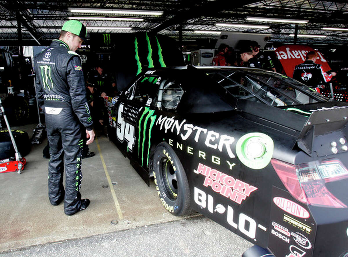 NASCAR driver Kurt Busch looks at his car in the garage area at Darlington Raceway during practice for the Nationwide Series auto race, Friday, May 11, 2012 in Darlington, S.C. (AP Photo/Mary Ann Chastain)