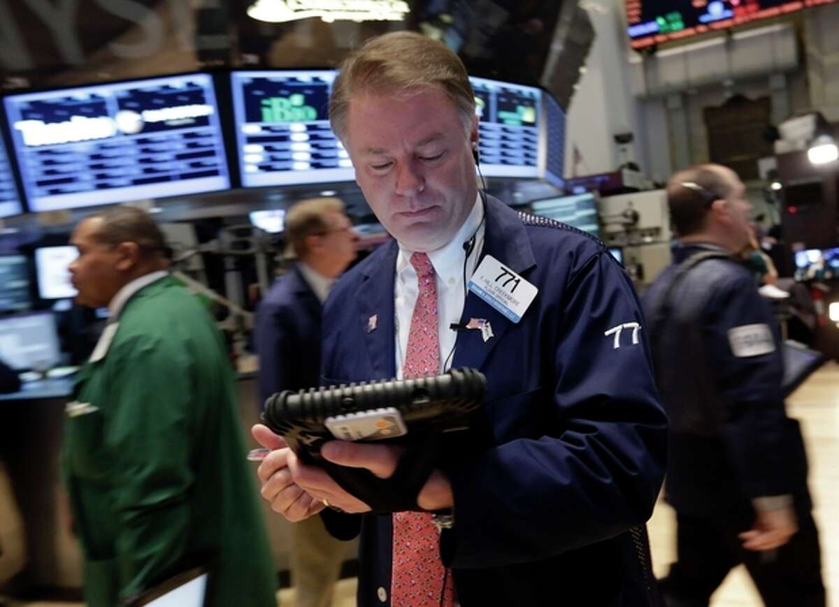 Trader F. Hill Creekmore works on the floor of the New York Stock Exchange Friday, March 8, 2013. Stocks are opening higher on Wall Street after the government reported a burst of hiring last month that sent the unemployment rate to a four-year low. (AP Photo/Richard Drew)