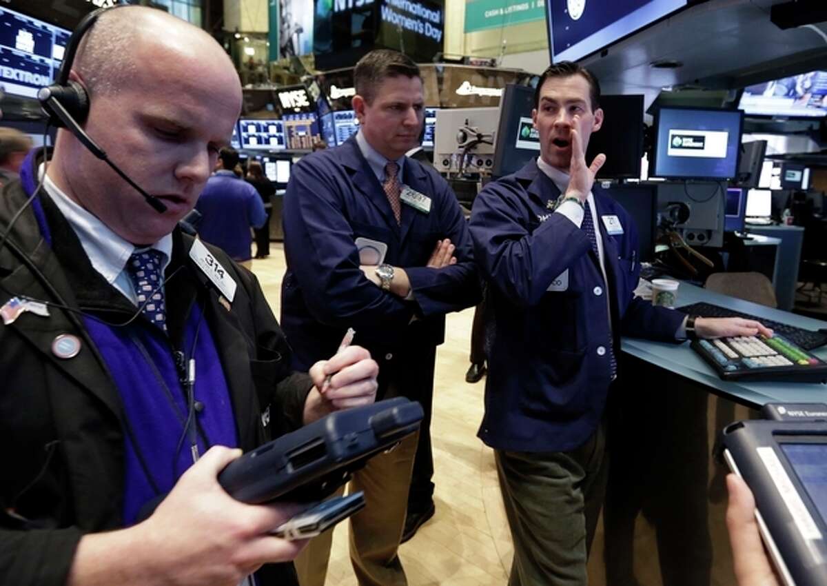 Specialist John McNierney, right, works on the floor of the New York Stock Exchange Friday, March 8, 2013. Stocks are opening higher on Wall Street after the government reported a burst of hiring last month that sent the unemployment rate to a four-year low. (AP Photo/Richard Drew)