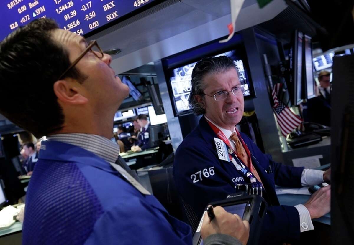 Specialist Donald Civitanova, right, works at his post on the floor of the New York Stock Exchange Friday, March 8, 2013. Stocks are opening higher on Wall Street after the government reported a burst of hiring last month that sent the unemployment rate to a four-year low. (AP Photo/Richard Drew)