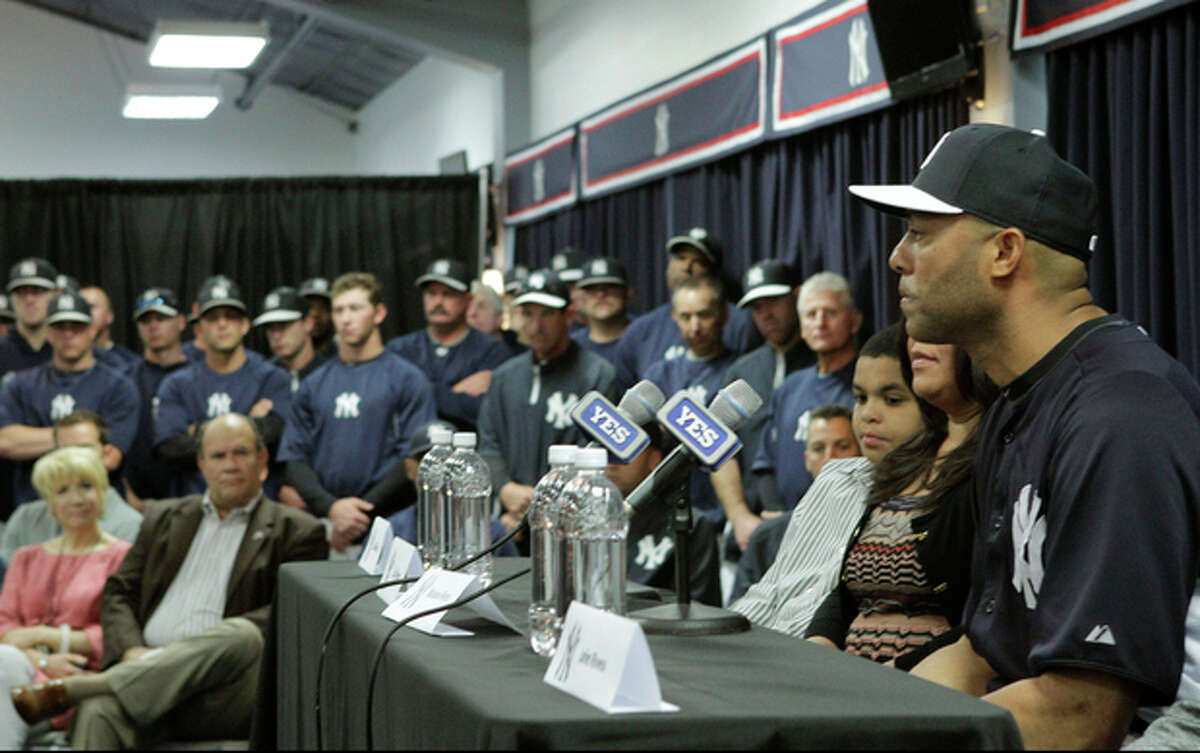 Yankees front office, coaches and teammates listen as New York Yankees pitcher Mariano Rivera, far right, who holds baseball's all-time saves record, announces his plans to retire at the end of the 2013 season during a news conference at Steinbrenner Field Saturday, March 9, 2013 in Tampa, Fla. (AP Photo/Kathy Willens)