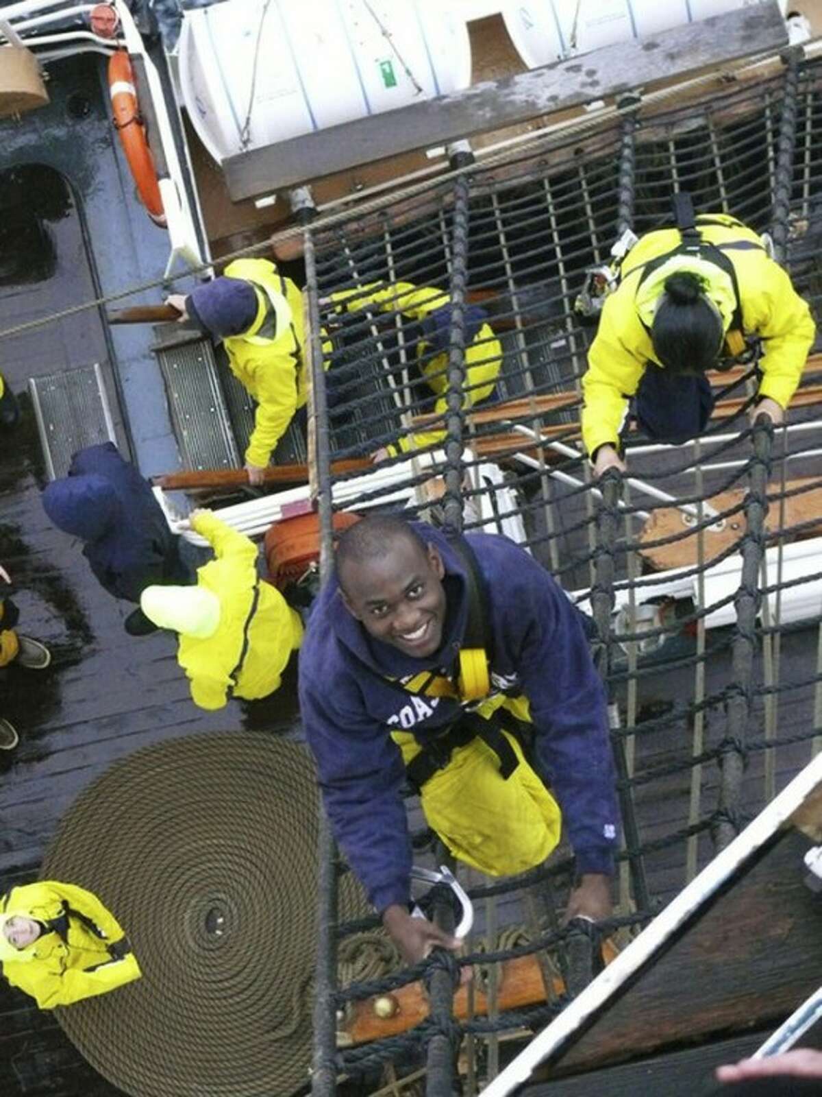 In this May 25, 2011 photo provided by the U.S. Coast Guard, U.S. Coast guard Academy, 1st Class, Cadet Orlando Morel climbs rigging aboard the Coast Guard Cutter Eagle. Morel was 6 years old when he and his mother were rescued by the Coast Guard while leaving Haiti. Morel, now of Rockville, Md., will graduate Wednesday, May 16, 2012, from the Coast Guard Academy in New London, Conn. (AP Photo/U.S. Coast Guard Academy)