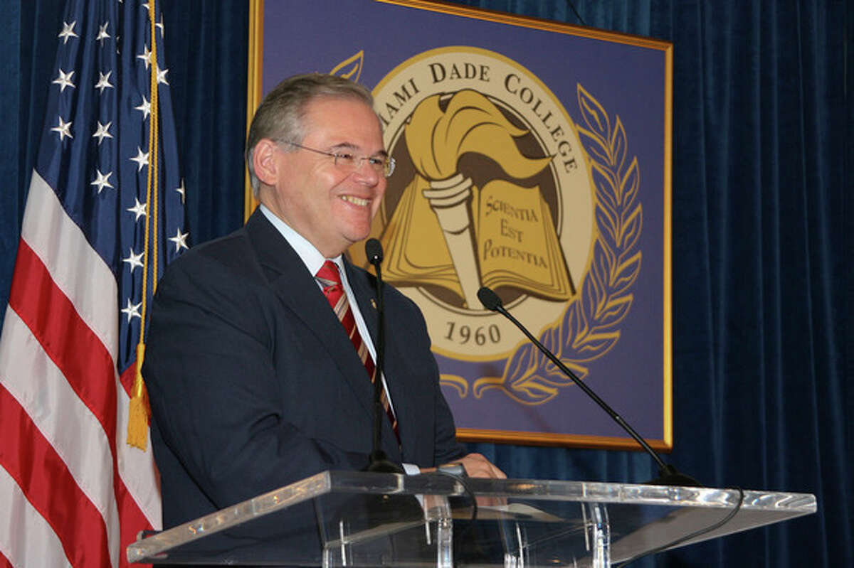 In this Jan. 31, 2010, image released by Miami Dade College, shows Sen. Robert Menendez, D-N.J., speaks at the signing of his book "Growing American Roots" at the college in Miami. Menendez sponsored legislation with incentives for natural gas vehicles conversions that would benefit the biggest political donor to his re-election, Dr. Salomon Melgen, the same eye doctor whose private jet Menendez used for two personal trips to the Dominican Republic, an Associated Press investigation found. (AP Photo/Miami Dade College, Phil Roche)