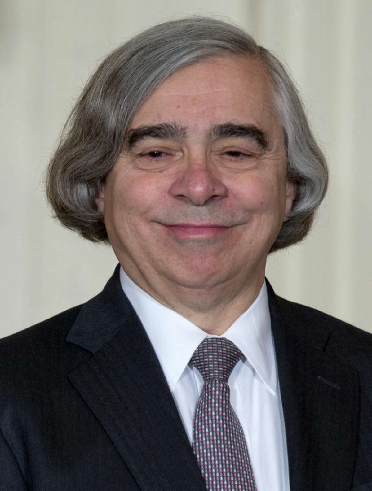 MIT physics professor Ernest Moniz smiles as he stands on stage in the East Room of the White House in Washington, Monday, March 4, 2013, where President Barack Obama announces he would nominate Moniz for Energy Secretary . (AP Photo/Carolyn Kaster)