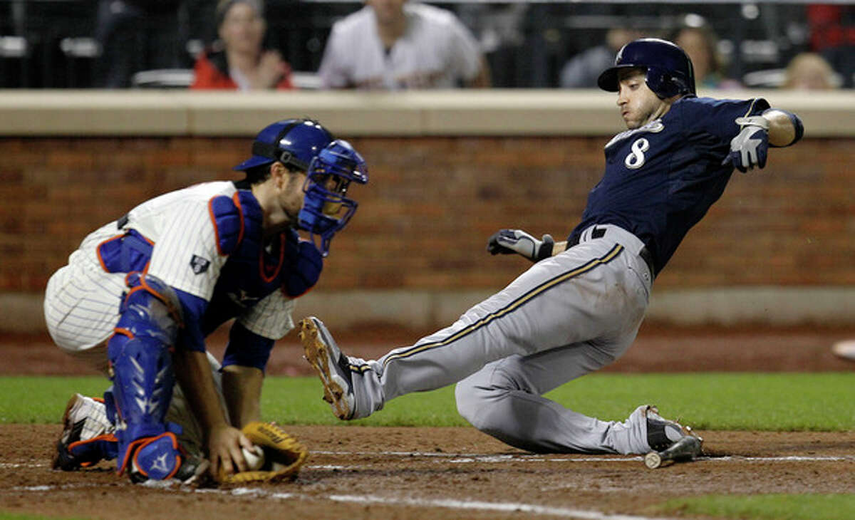 Milwaukee Brewers left fielder Ryan Braun (8) slides home ahead of the tag from New York Mets catcher Mike Nickeas, scoring on Jonathan Lucroy's RBI single during the sixth inning of their baseball game at Citi Field in New York, Tuesday, May 15, 2012. (AP Photo/Kathy Willens)