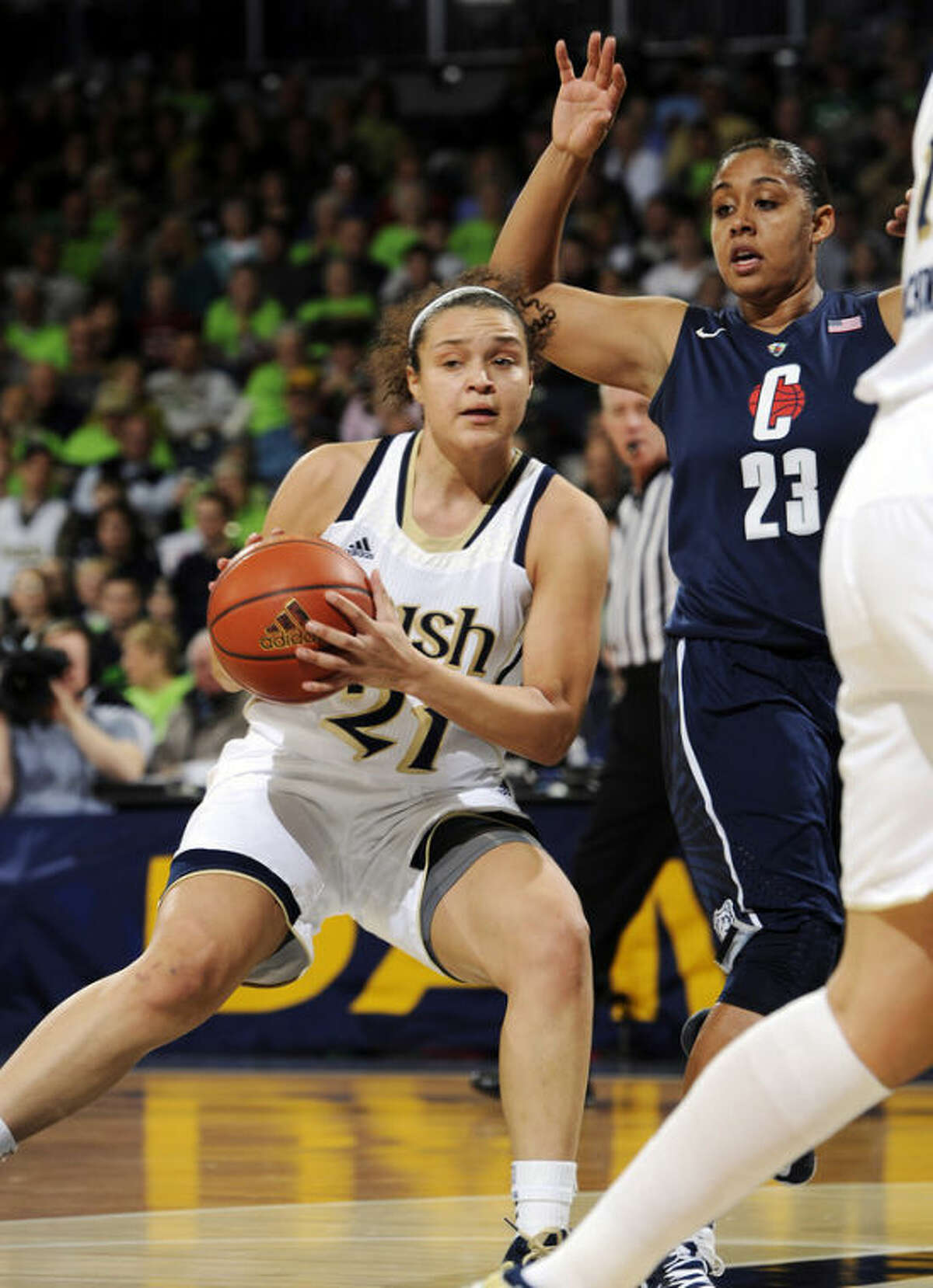 Notre Dame guard Kayla McBride, left, throws a pass around Connecticut guard Kaleena Mosqueda-Lewis during the first half of an NCAA college basketball game, Monday, March 4, 2013, in South Bend, Ind. (AP Photo/Joe Raymond)