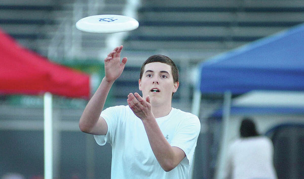 Hour Photo/ Alex von Kleydorff. John DeMattia grabs a Frisbee during Wiltons Relay for Life.