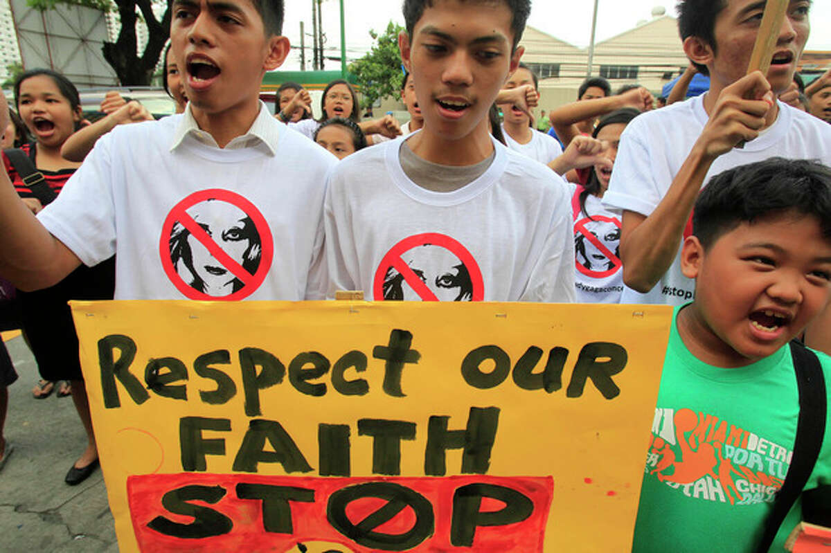Filipino Christian youths chant "Stop the Lady Gaga concerts" during a rally, calling for the cancellation of the singer's May 21-22 concerts, outside the Pasay City Hall in Pasay, south of Manila, Philippines, Friday, May 18, 2012. The youths said they are offended by Lady Gaga's music and videos, in particular her song "Judas" which they say mocks Jesus Christ. Lady Gaga's concert was marked also by protest from evangelical groups in South Korea and the singer scrapped an Indonesia concert following protests from conservative Muslims. (AP Photo/Bullit Marquez)