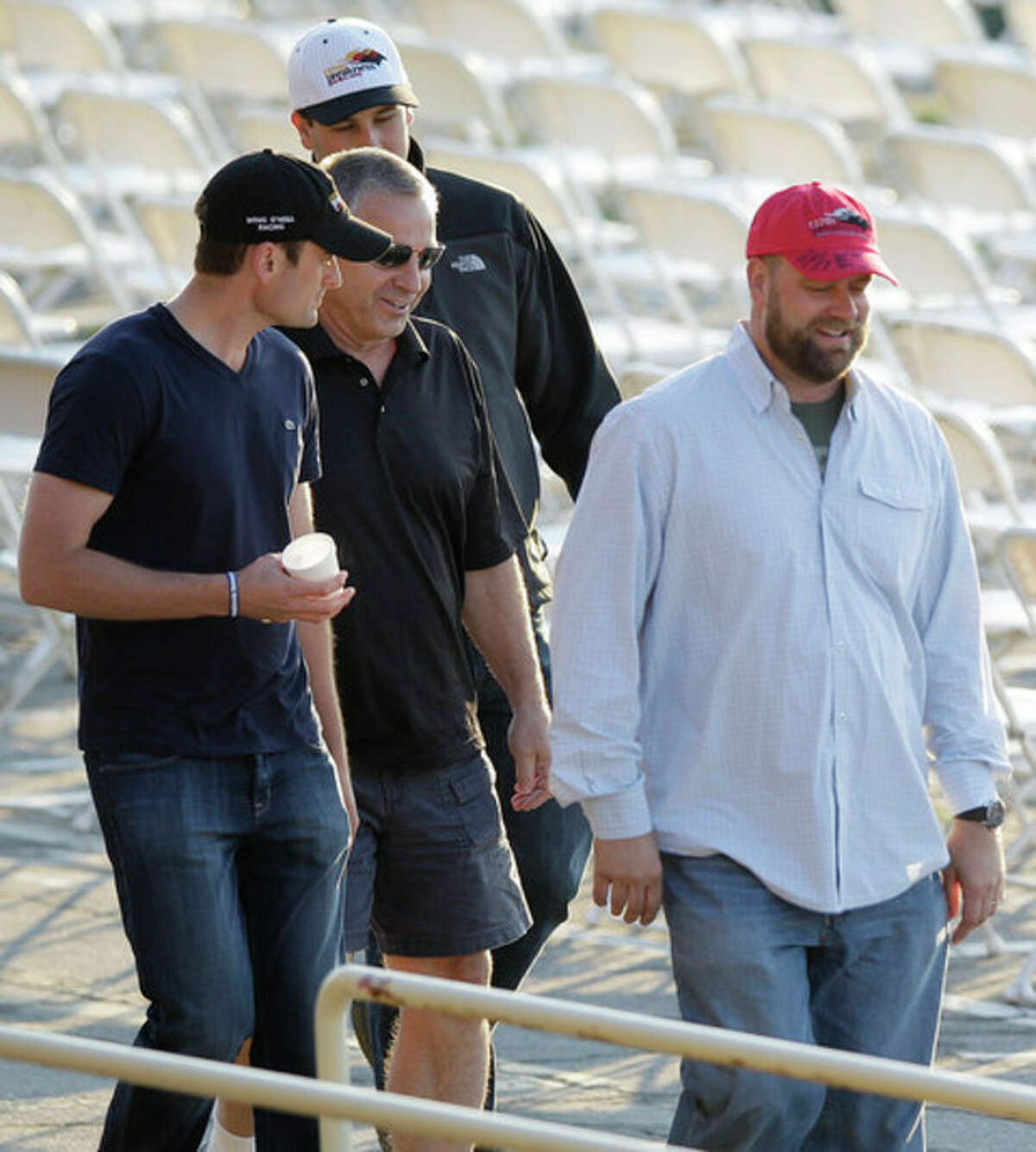 I'll Have Another trainer Doug O'Neill, right, walks in the stands during a morning workout at Pimlico Race Course, Friday, May 18, 2012, in Baltimore. The Preakness Stakes horse race takes place Saturday at Pimlico. (AP Photo/Patrick Semansky)