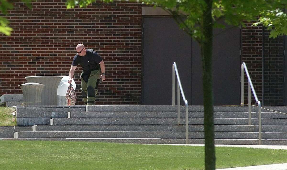 Hour Photo/ Alex von Kleydorff. Stamford Bomb Squad removes a bag from a trash bin outside the Courthouse.