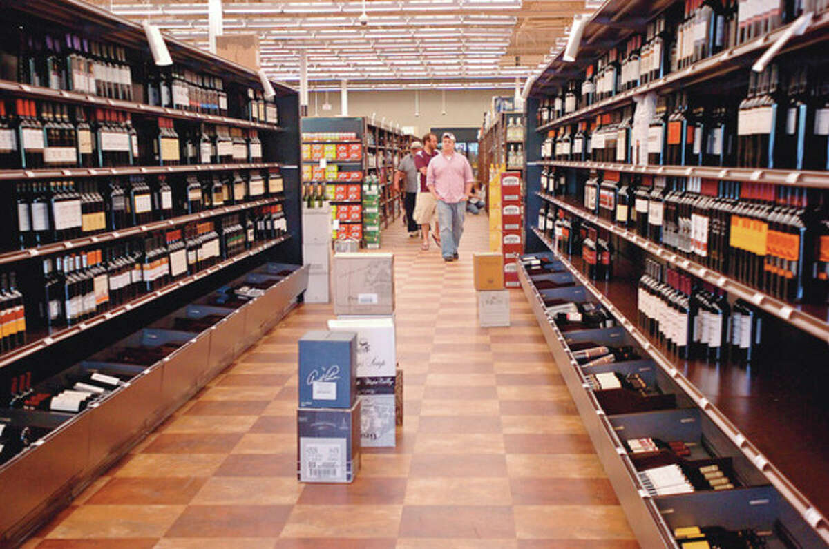 Customers look over the selection at Wine Nation on Main Ave in Norwalk. Hour photo / Erik Trautmann