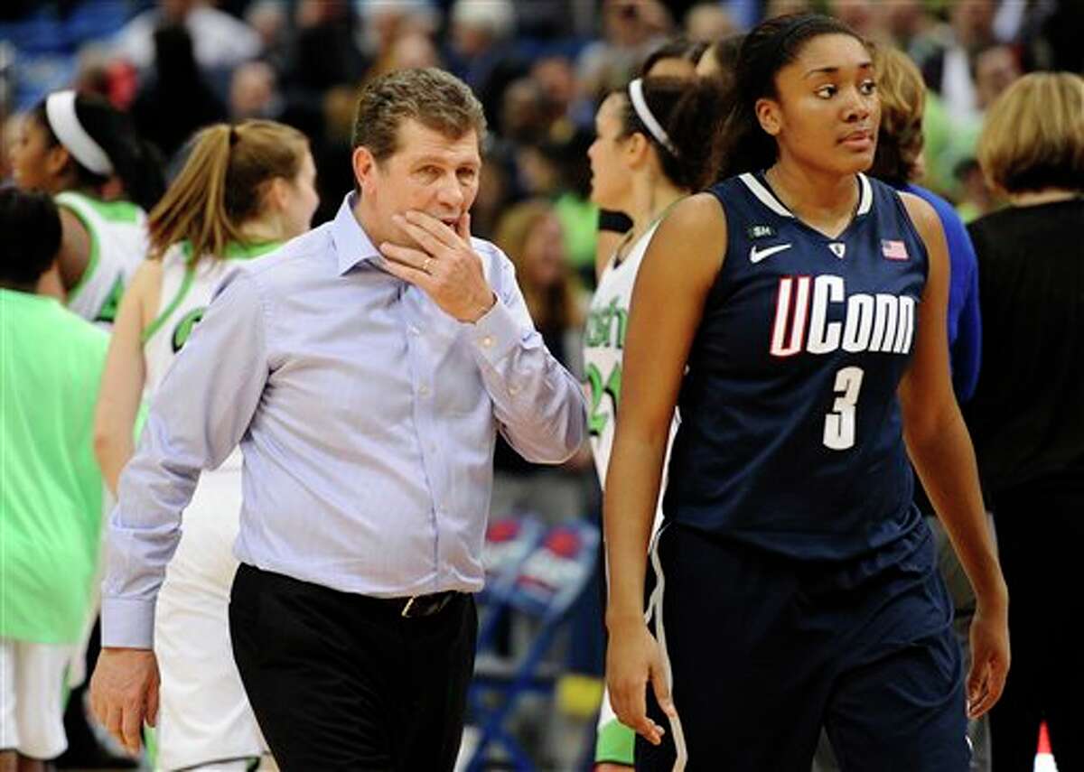 Connecticut head coach Geno Auriemma left, walks off the court with Connecticut's Morgan Tuck after their 61-59 loss to Notre Dame in an NCAA college basketball game in the final of the Big East Conference women's tournament in Hartford, Conn., Tuesday, March 12, 2013. (AP Photo/Jessica Hill)