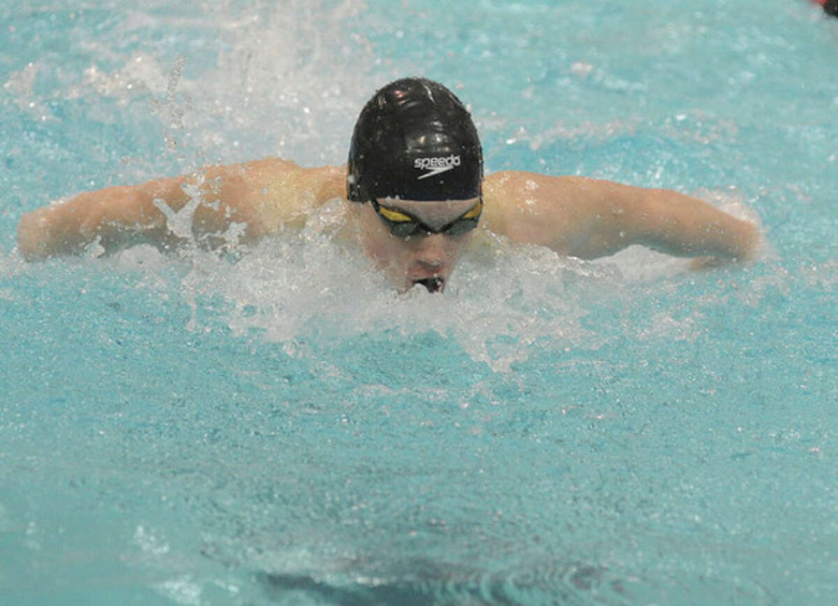 Hour Photo/Matthew Vinci Wilton's Thomas Kealy swims the 100 butterfly at Tuesday's Class L state championship swim meet. Kealy won the event, and also won the 50 freestyle. Wilton used a win in the meet-ending relay to take second place from Darien.