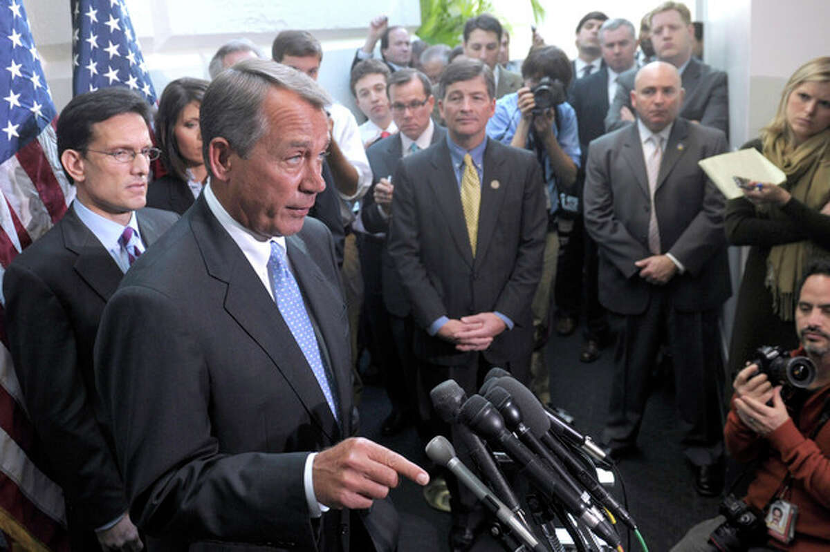 House Speaker John Boehner of Ohio, flanked by House Majority Leader Eric Cantor, R-Va., left, and Rep. Jeb Hensarling, R-Texas, center, speaks to reporters on Capitol Hill in Washington, Wednesday, Nov. 30, 2011, following a closed-door meeting. (AP Photo/Susan Walsh)