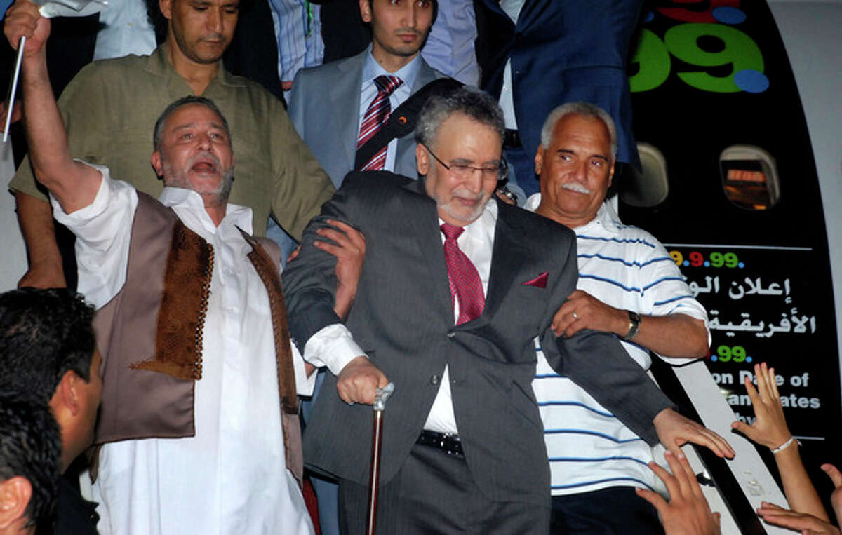 FILE This Thursday, Aug. 20, 2009 file photo shows Libyan Abdel Baset al-Megrahi, who was found guilty of the 1988 Lockerbie bombing, center, being helped down the airplane steps on his arrival at an airport in Tripoli, Libya. Abdel Baset al-Megrahi, a Libyan intelligence officer who was the only person ever convicted in the 1988 Lockerbie bombing, died Sunday May 20, 2012 nearly three years after he was released from a Scottish prison to the outrage of the relatives of the attack's 270 victims. He was 60. (AP Photo)