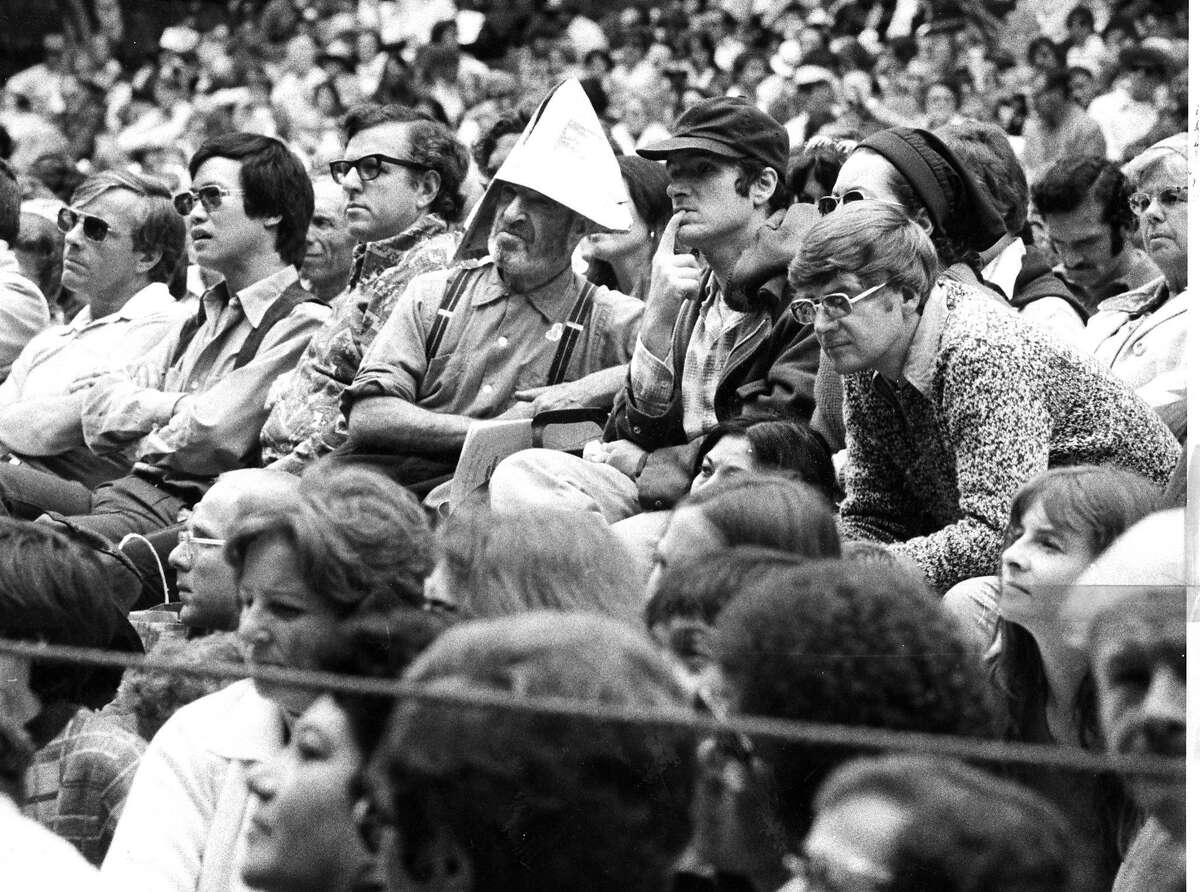 A concertgoer crafted a paper hat to give him relief from the sun at the concert at Sigmund Stern Grove. Photo ran 08/18/1975, P. 3