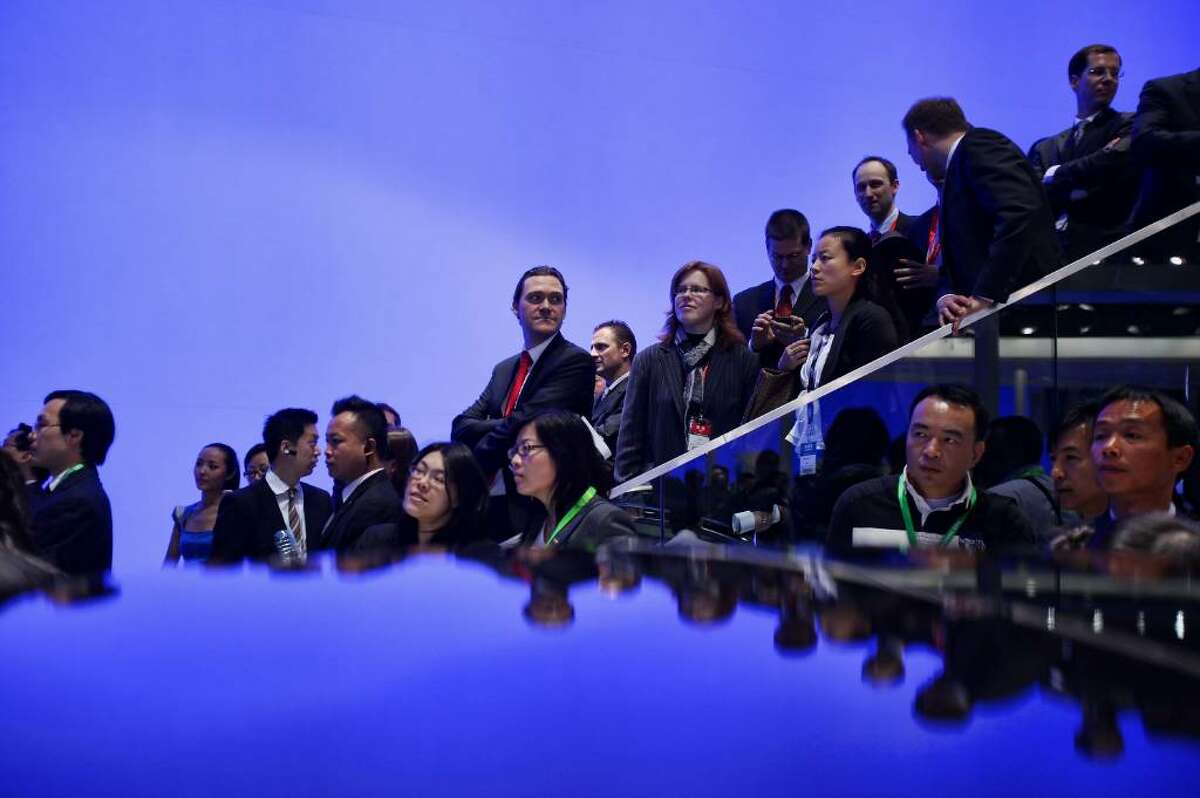 BEIJING - APRIL 23: Visitors wait before a news conference of Volkswagen during a special media opening of the Beijing Auto Show on April 23, 2010 in Beijing of China. Major global automakers plan to unveil dozens of new models at the Beijing auto show, which has quickly become one of the biggest and most important auto shows in the world and raises its curtains on Friday and will last till May 2, during which 990 models - with 89 making their global debut - will be displayed in a 200,000-sq-m area. (Photo by Feng Li/Getty Images)
