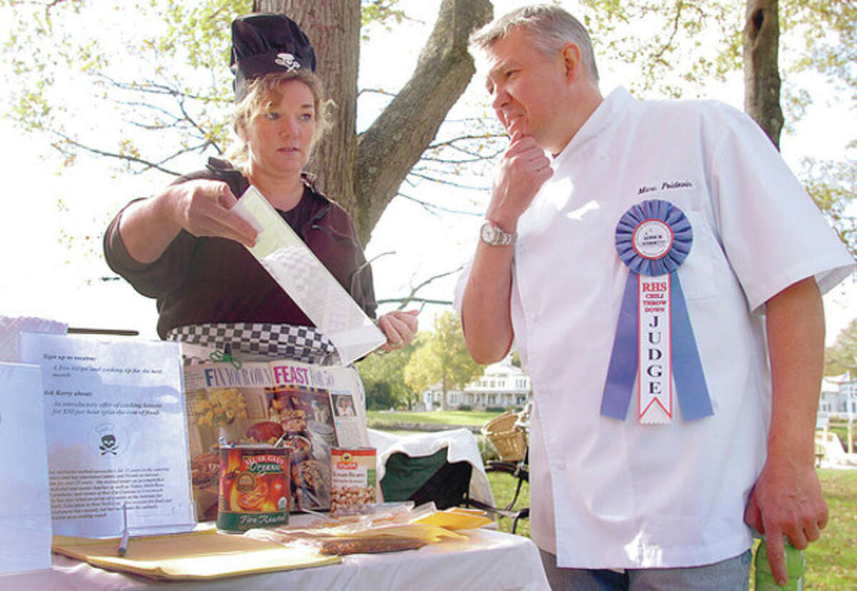 Above left, Kerry McFarlin gets judged by Marc Poidevin of Rowayton Market at the Chili Throwdown. Above right, David McCart serves up chili.