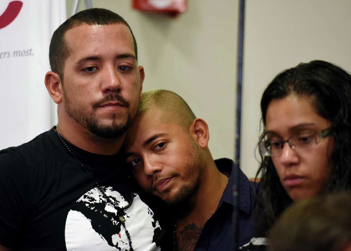 Unidentified family members of Pulse nightclub shooting victim Angel Colon look on as Colon speaks during a news conference at Orlando Regional Medical Center on Tuesday, June 14, 2016 in Orlando, Fla. Several doctors and Colon spoke to the media Tuesday. (Chris Urso/Tampa Bay Times via AP) MANDATORY CREDIT