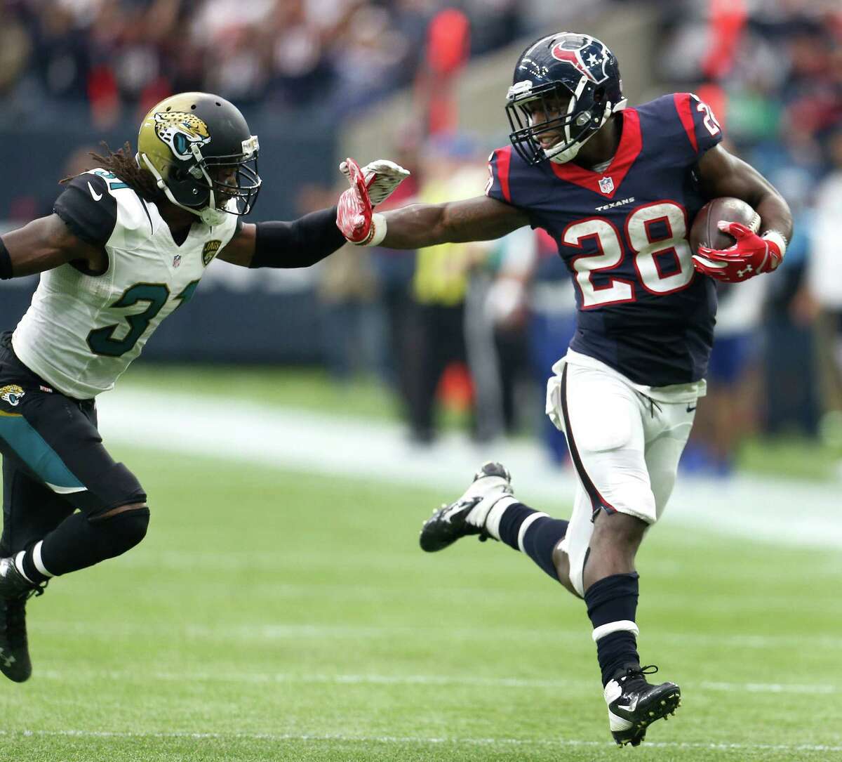 Alfred Blue, right, probably won't get as much hand-on work this season as he did last year, when he led the Texans in carries and yards rushed.
