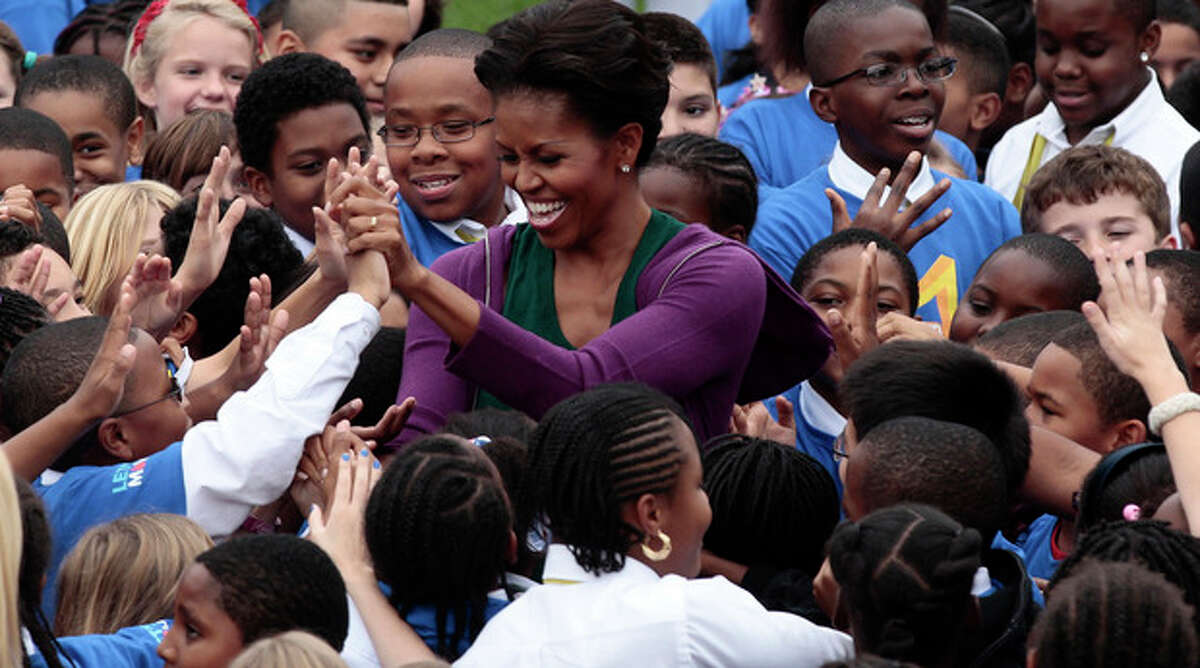 First lady Michelle Obama hosts local children on the South Lawn of the White House in Washington as they attempt to break the Guinness World Records title for the most people doing jumping jacks in a 24-hour period, Tuesday, Oct., 11, 2011. (AP Photo/Pablo Martinez Monsivais)