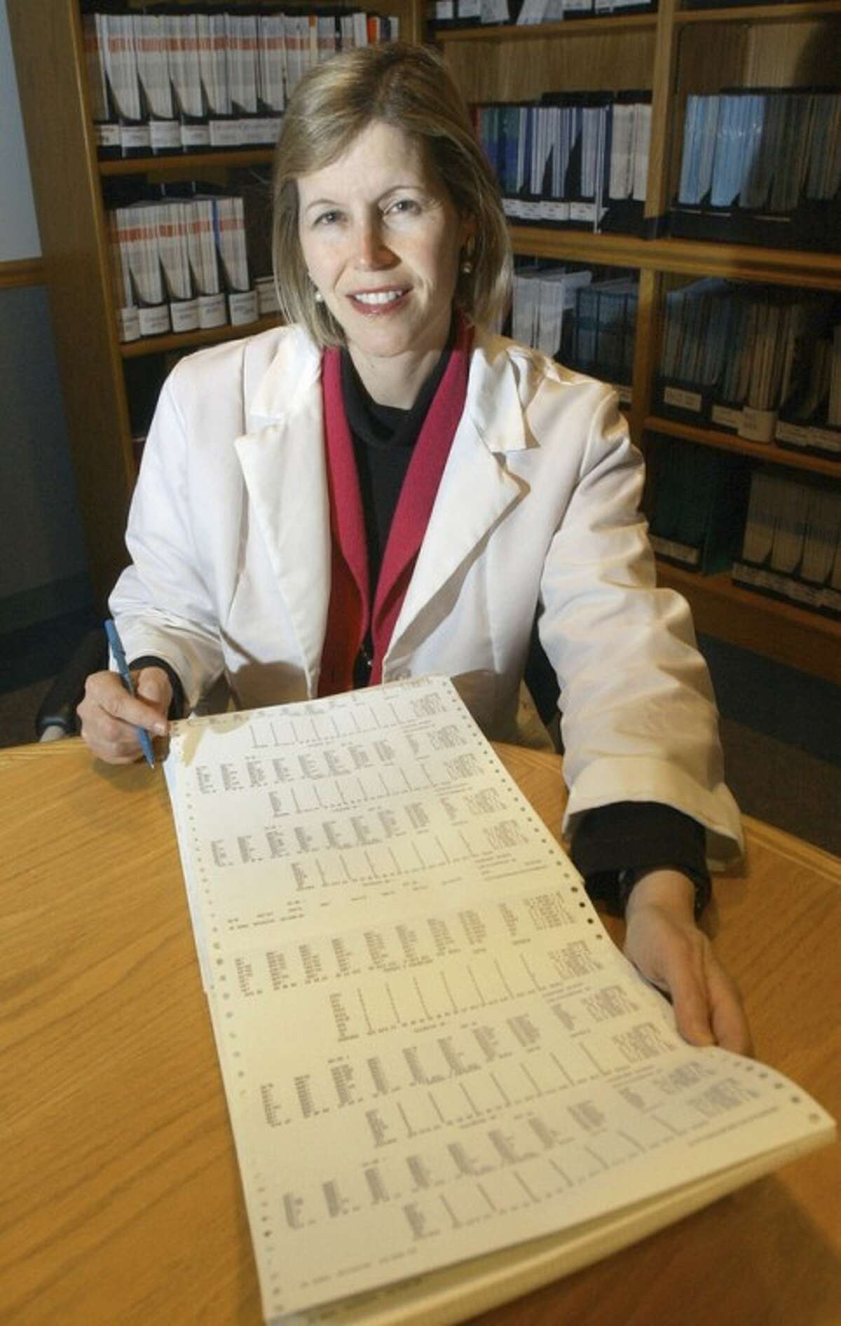 FILE - In this Dec. 12, 2002 file photo, Dr. JoAnn Manson poses for a photo in Boston. Manson, chief of preventive medicine at Harvard's Brigham and Women's Hospital, says women employees are less likely than men to ask her for pay raises, a phenomenon she says may explain results of a new study showing women doctor-researchers get paid substantially less than their male counterparts. The study involving 800 doctors nationwide appears Wednesday, June 12, 2012, in Journal of the American Medical Association. (AP Photo/Elise Amendola, File)