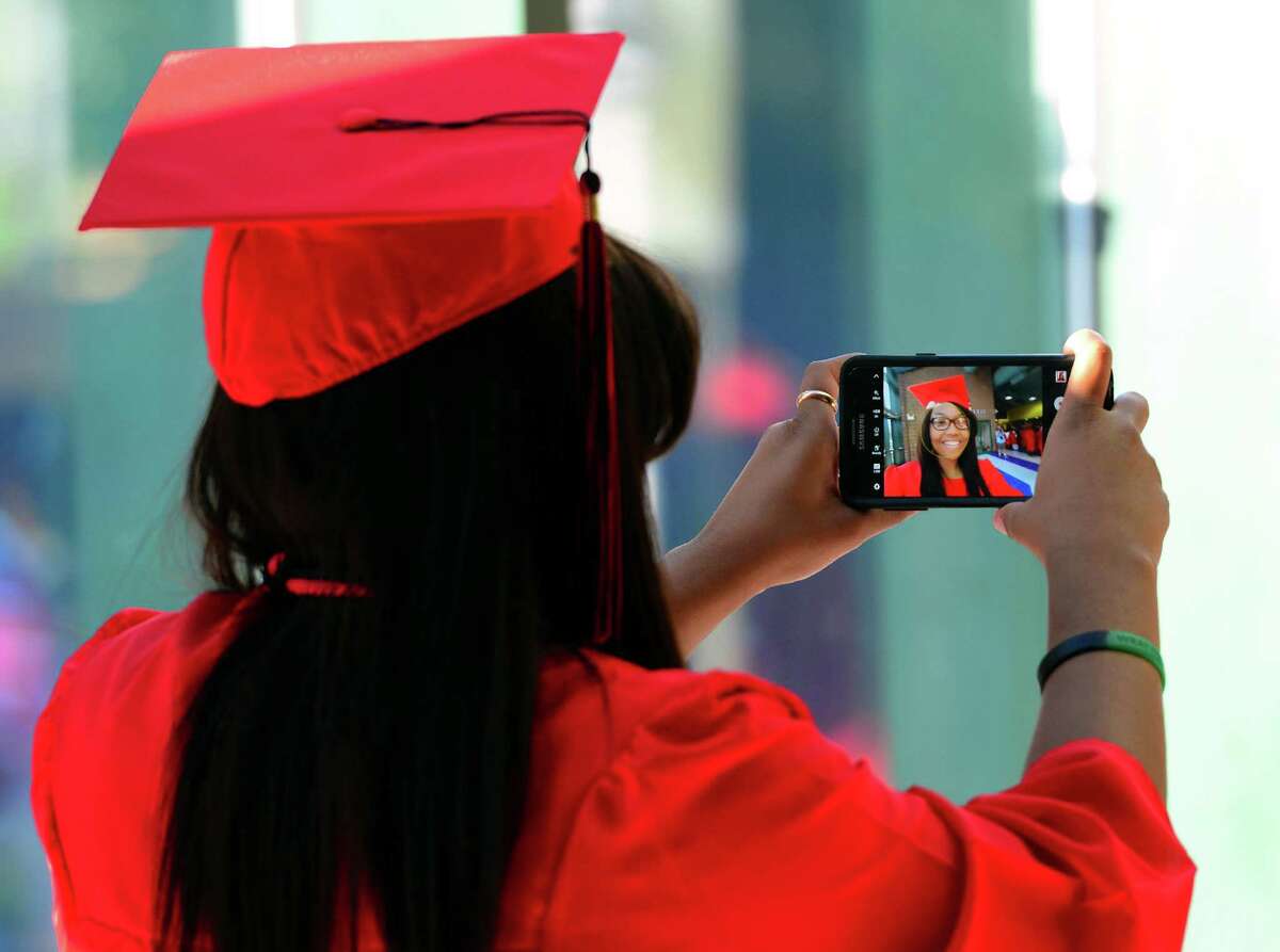 Graduate Brittany Staton snaps a selfie before the start of Central High School's Class of 2016 Graduation Exercises at the Webster Bank Arena in Bridgeport, Conn., on Tuesday June 14, 2016.