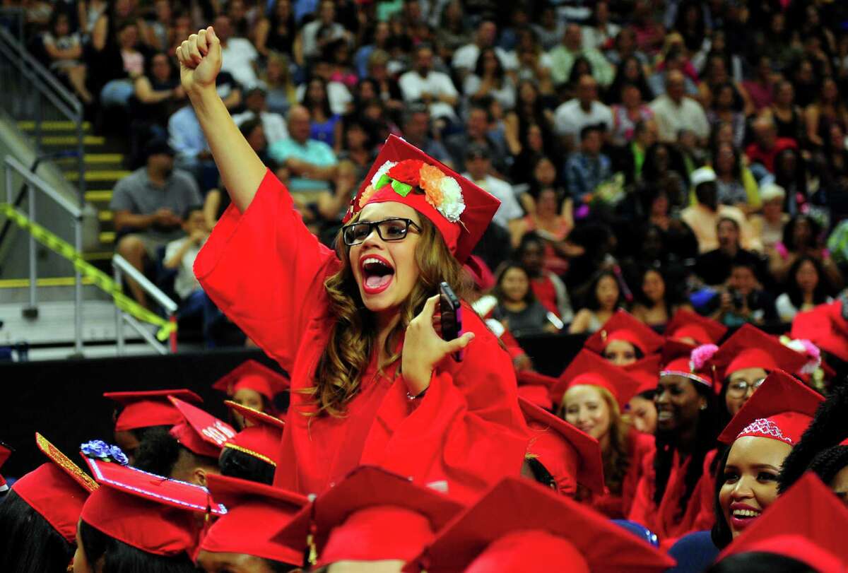 Graduate Kimberly Berrios cheers for a classmate during Central High School's Class of 2016 Graduation Exercises at the Webster Bank Arena in Bridgeport, Conn., on Tuesday June 14, 2016.