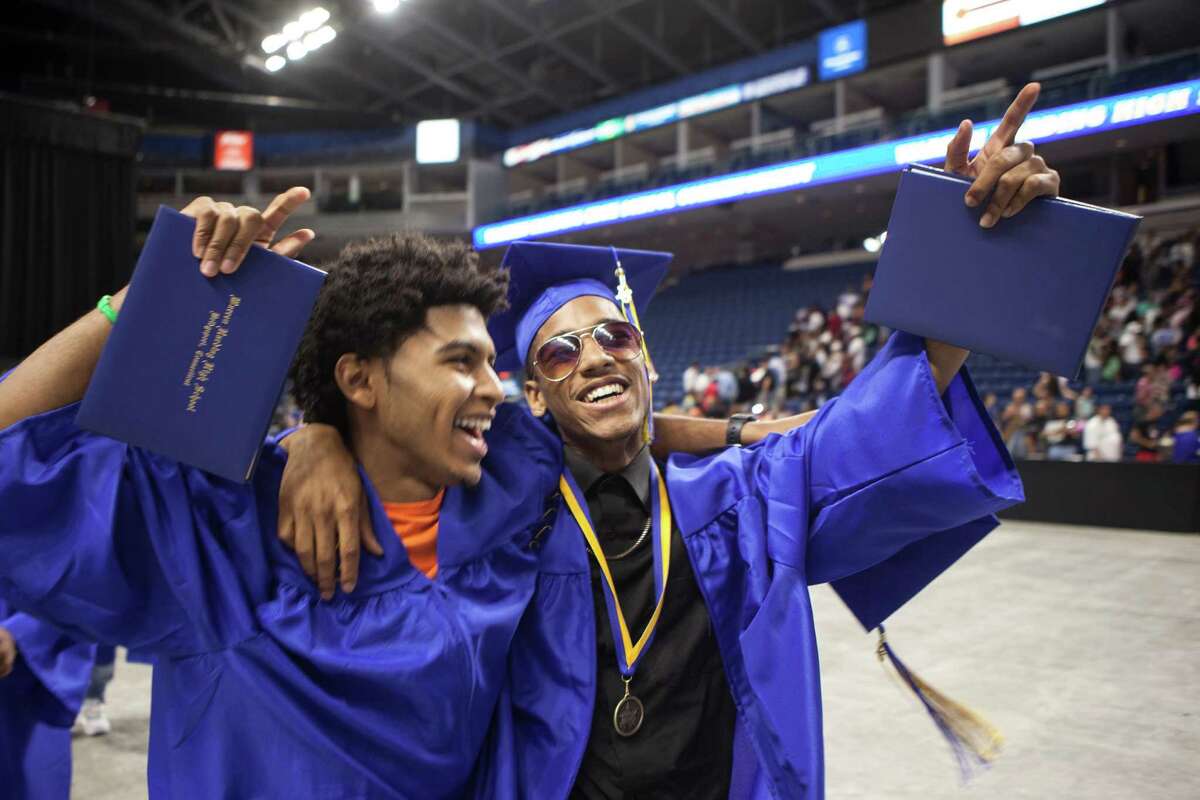 Jason Spencer and Donte Rodrigues celebrate as they leave the 90th Annual Commencement Ceremony for Warren Harding High School at Webster Bank Arena in Bridgeport, Conn. on Tuesday, June 14, 2016.