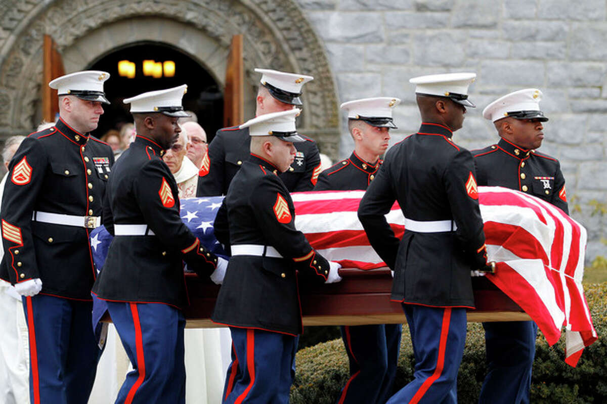 Marines carry the coffin of Lance Cpl. Roger Muchnick Jr. after funeral services at St. Ann's Parish in Lenox, Mass. on Friday, March 29, 2013. Muchnick was one of seven Marines killed on March 18 when a mortar shell exploded in its firing tube during an exercise at Hawthorne Army Depot in Nevada. He was 23. The accident remains under investigation. Muchnick grew up in Westport, Conn (AP Photo/The Berkshire Eagle, Stephanie Zollshan)