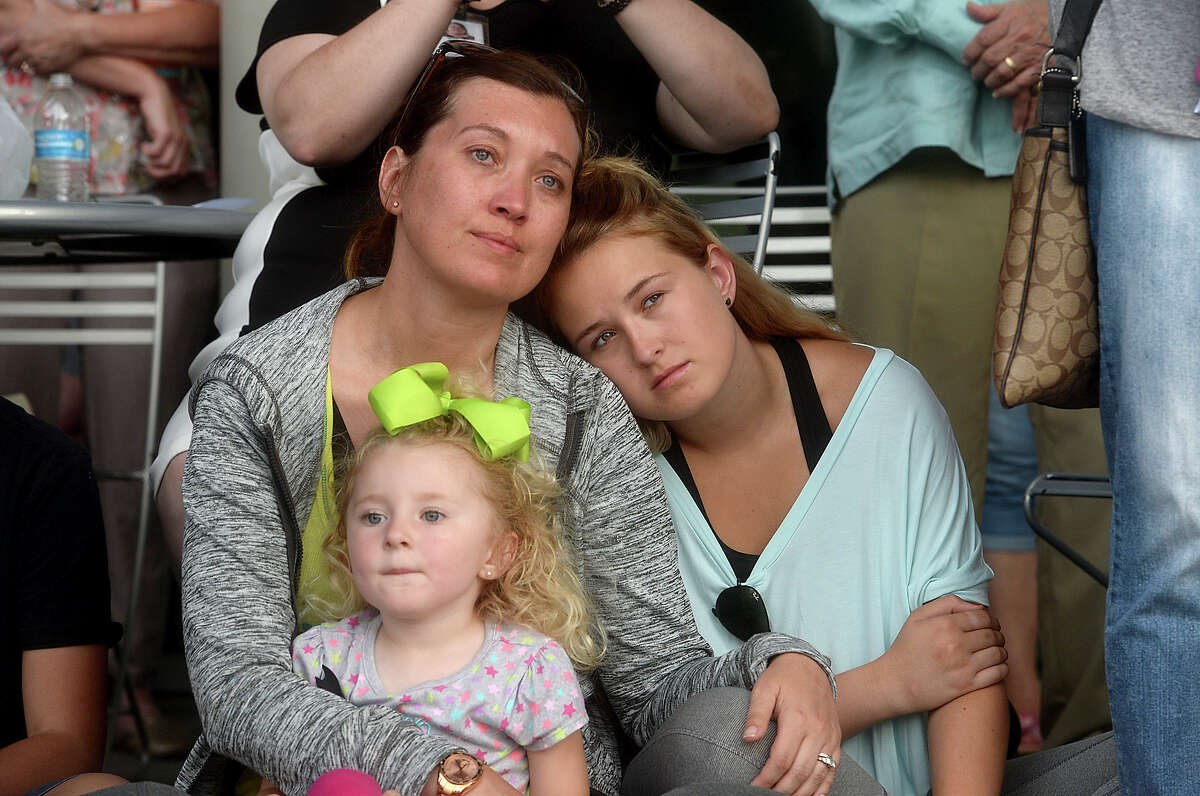 Amy Haden holds onto her children Alexa McWhirter, 19, and Aubrey Haden, 3, as they gather with others at Beaumont's community-wide vigil honoring the victims of Sunday's mass shooting at Pulse, a gay nightclub in Orlando, Tuesday at the Event Centre. Several local officials, faith leaders, and members of other organizations addressed the large crowd, offering words of sorrow, faith, and hope. The event closed with a reading of the names and ages of the 49 victims who died in the tragedy. Photo taken Tuesday, June 14, 2016 Kim Brent/The Enterprise