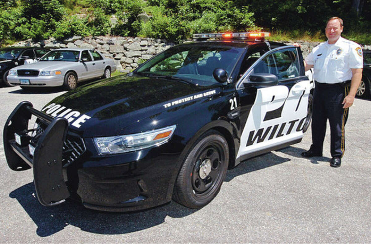 Photo by Erik Trautmann Deputy Chief Robert Crosby, of the Wilton Police Department, with one of the department's new cruisers. The department ordered six new vehicles for its fleet, including the above Ford Interceptor sedan, a car made specially for law enforcement.