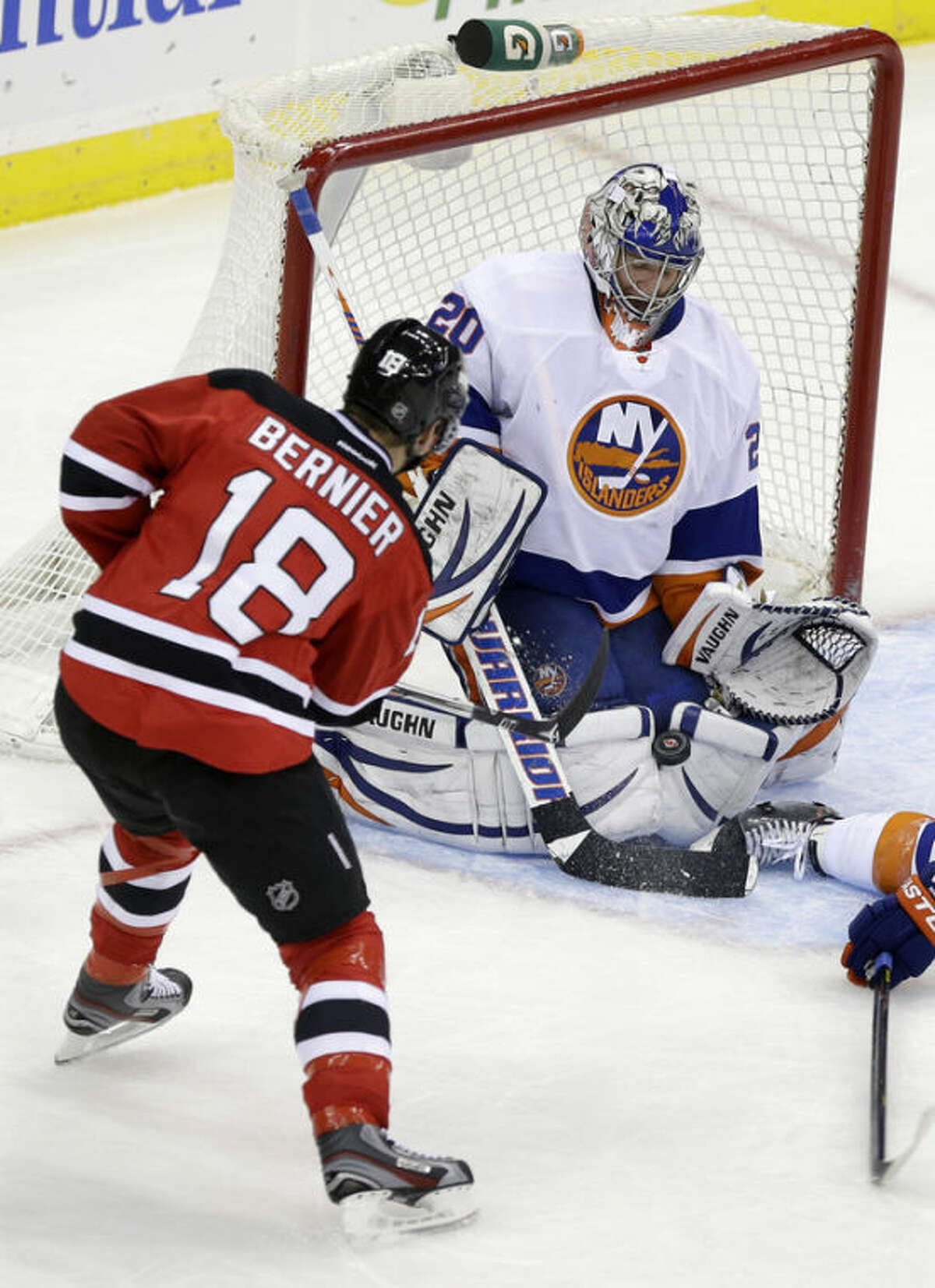 New York Islanders goalie Evgeni Nabokov (20) of Kazakhstan makes a save off his pads on a shot by New Jersey Devils' Steve Bernier (18) during the second period of an NHL hockey game Monday, April 1, 2013, in Newark, N.J. (AP Photo/Mel Evans)
